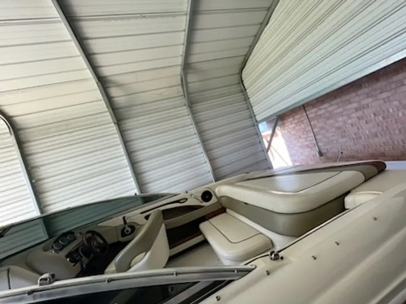 Slide: The Image of Interior of a 2006 Sea Ray 220 Select boat in a garage. - 5