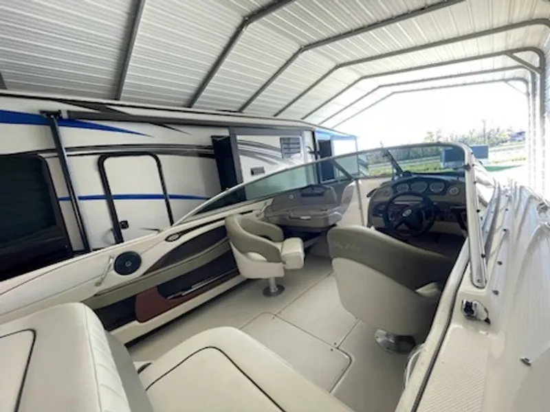 Slide: The Image of Interior of a 2006 Sea Ray 220 Select boat in a garage. - 7