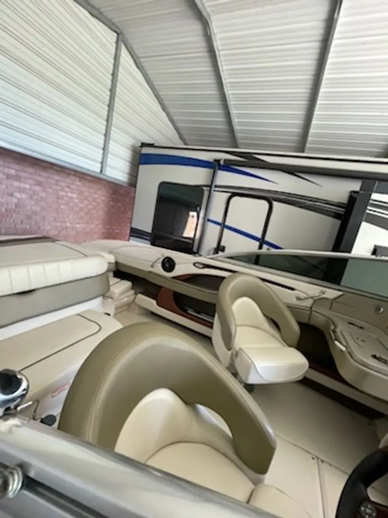 Slide: The Image of Interior of a 2006 Sea Ray 220 Select boat in a garage. - 9