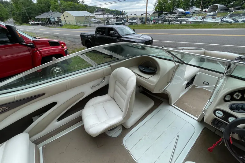 Slide: The Image of Interior of a 2000 Mariah 202 Shabah boat with white seating and dashboard. - 11