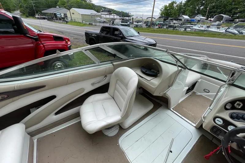 Slide: The Image of Interior of a 2000 Mariah 202 Shabah boat with white seating and dashboard. - 12