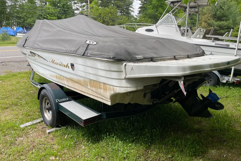 Slide: The Image of Covered 2000 Mariah 202 Shabah boat on trailer, parked on grass. - 2