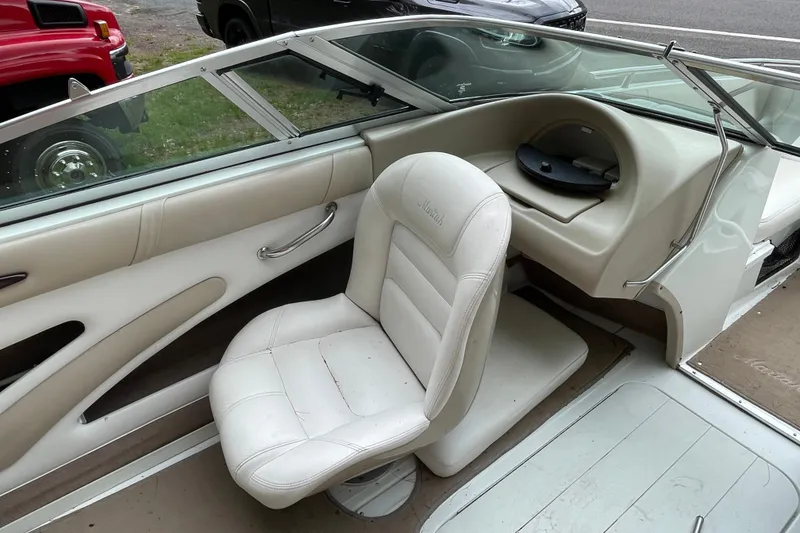 Slide: The Image of Interior of a 2000 Mariah 202 Shabah boat with white seating and dashboard. - 4