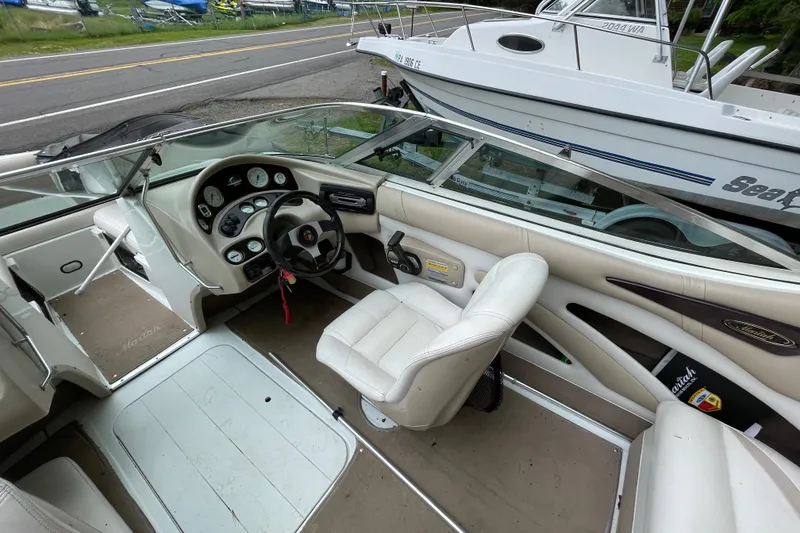 Slide: The Image of Interior of a 2000 Mariah 202 Shabah boat with steering wheel and dashboard. - 9