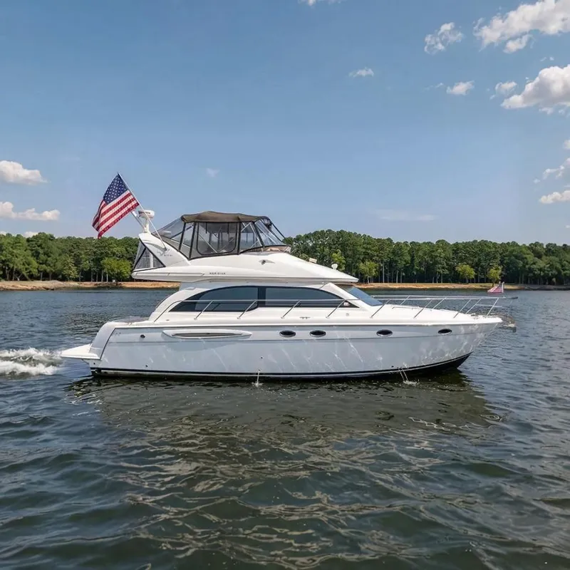 The Image of 2003 Meridian 411 Sedan yacht on a serene lake with American flag. - 0