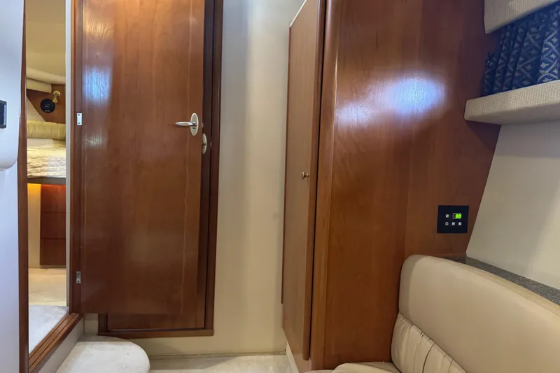 Slide: The Image of Interior of a 2003 Meridian 411 Sedan yacht, featuring wooden cabinetry and beige seating. - 17