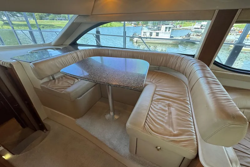 Slide: The Image of Luxurious interior of a 2003 Meridian 411 Sedan yacht with leather seating and waterfront view. - 19
