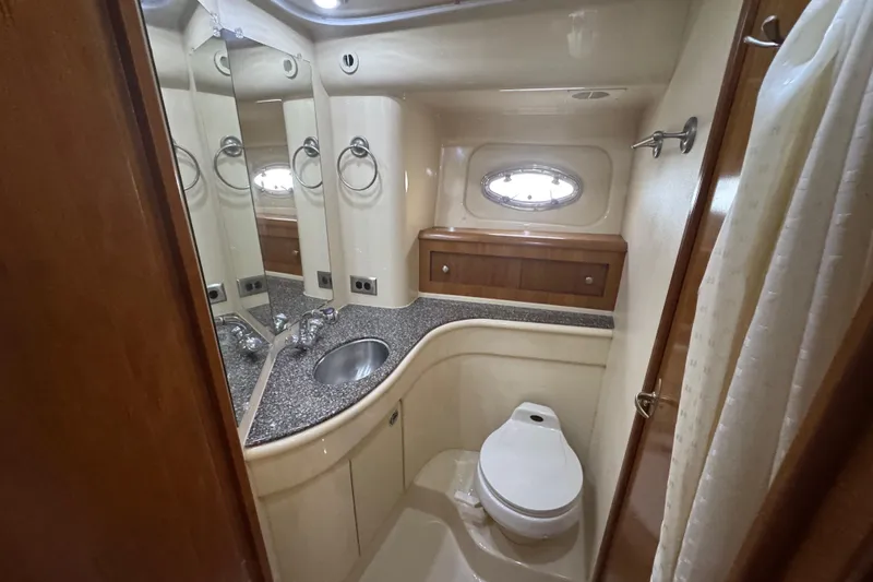 Slide: The Image of Luxurious bathroom in 2003 Meridian 411 Sedan yacht with modern fixtures and porthole window. - 26