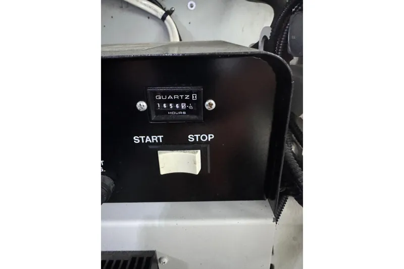 Slide: The Image of Control panel with hour meter and start-stop switch on 2003 Meridian 411 Sedan. - 33