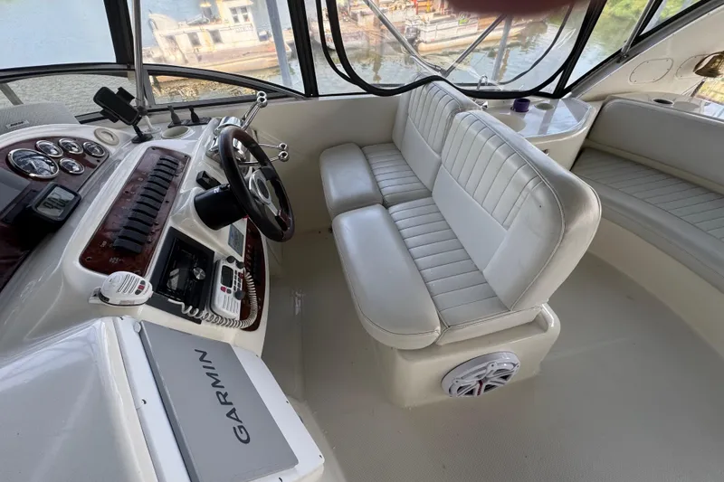 Slide: The Image of 2003 Meridian 411 Sedan helm with white seating, steering wheel, and Garmin navigation system. - 7