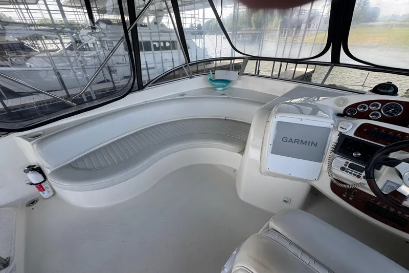 Slide: The Image of 2003 Meridian 411 Sedan yacht cockpit with Garmin navigation system and seating area. - 8