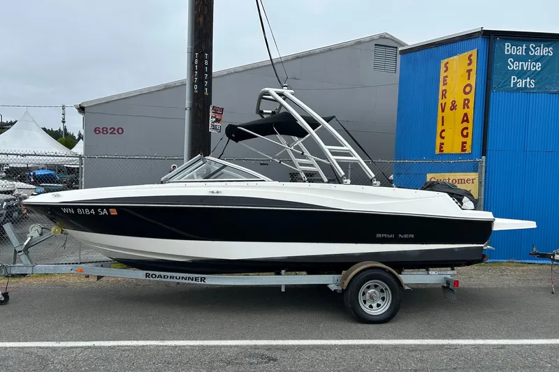 The Image of 2013 Bayliner 195 Bowrider on trailer near boat sales and service facility. - 0