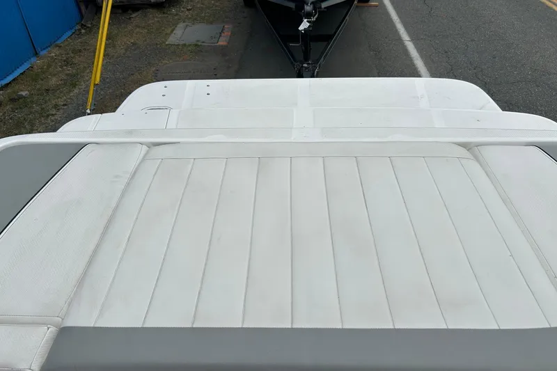 Slide: The Image of 2013 Bayliner 195 Bowrider boat interior with white cushioned seating. - 10