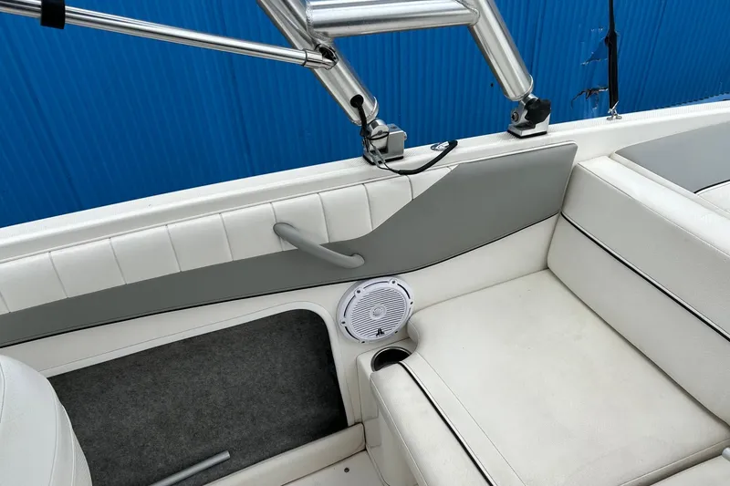 Slide: The Image of Interior of a 2013 Bayliner 195 Bowrider boat with white seating and speaker. - 11