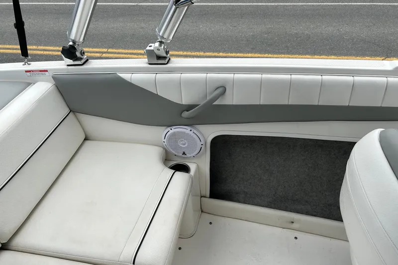 Slide: The Image of Interior of a 2013 Bayliner 195 Bowrider boat with white seating and speaker. - 12