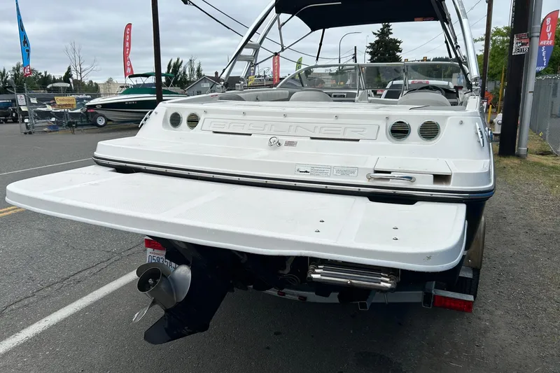Slide: The Image of 2013 Bayliner 195 Bowrider boat rear view with swim platform and outboard motor. - 2
