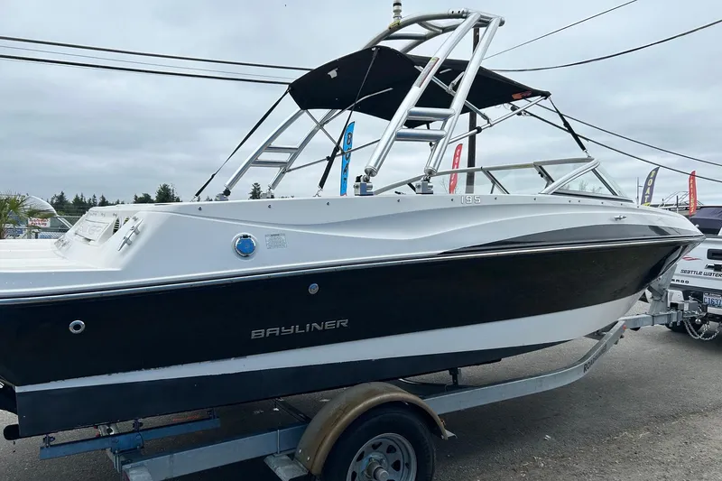 Slide: The Image of 2013 Bayliner 195 Bowrider boat on trailer, featuring sleek design and sturdy build. - 3
