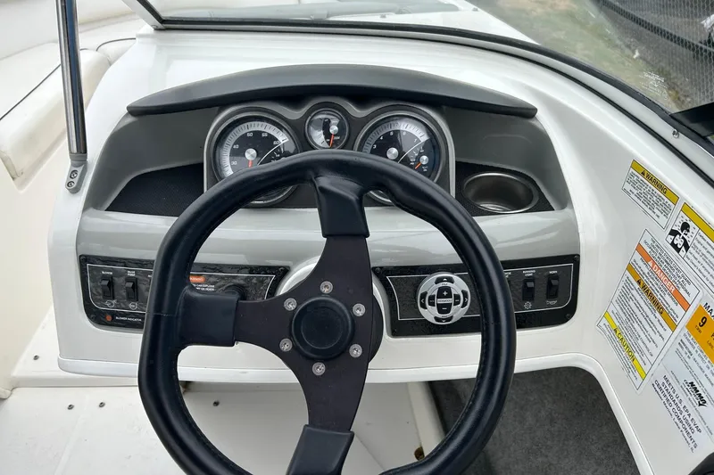 Slide: The Image of 2013 Bayliner 195 Bowrider dashboard with steering wheel and instrument panel. - 4