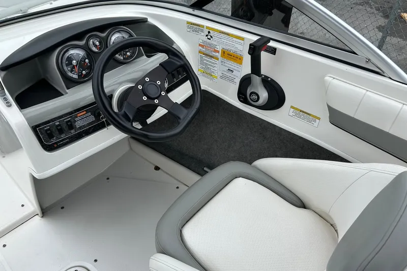 Slide: The Image of 2013 Bayliner 195 Bowrider cockpit with steering wheel and control panel. - 5