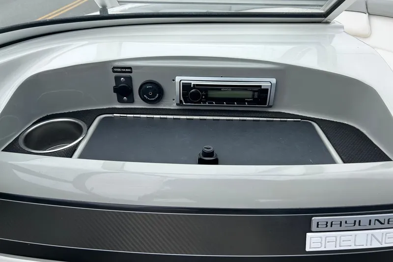 Slide: The Image of 2013 Bayliner 195 Bowrider dashboard with stereo and cup holder. - 6