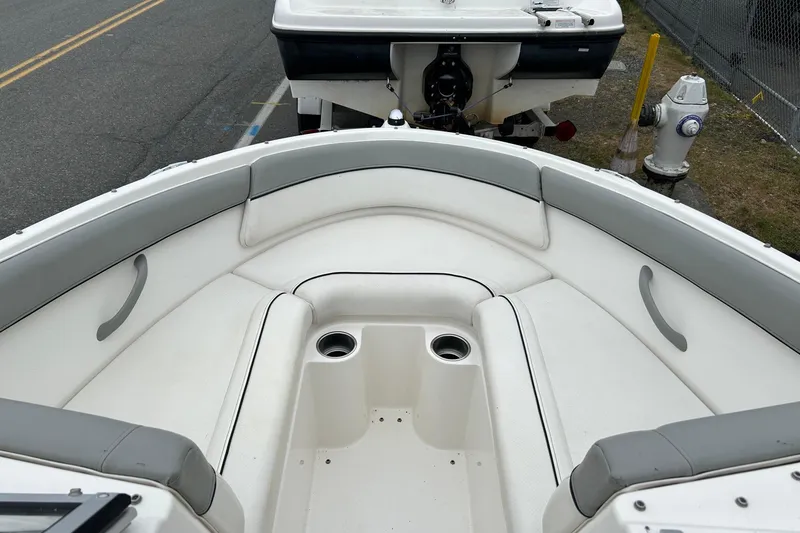Slide: The Image of 2013 Bayliner 195 Bowrider boat interior with cushioned seating and cup holders. - 8