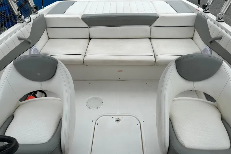 Slide: The Image of 2013 Bayliner 195 Bowrider interior with white and gray seating arrangement. - 9