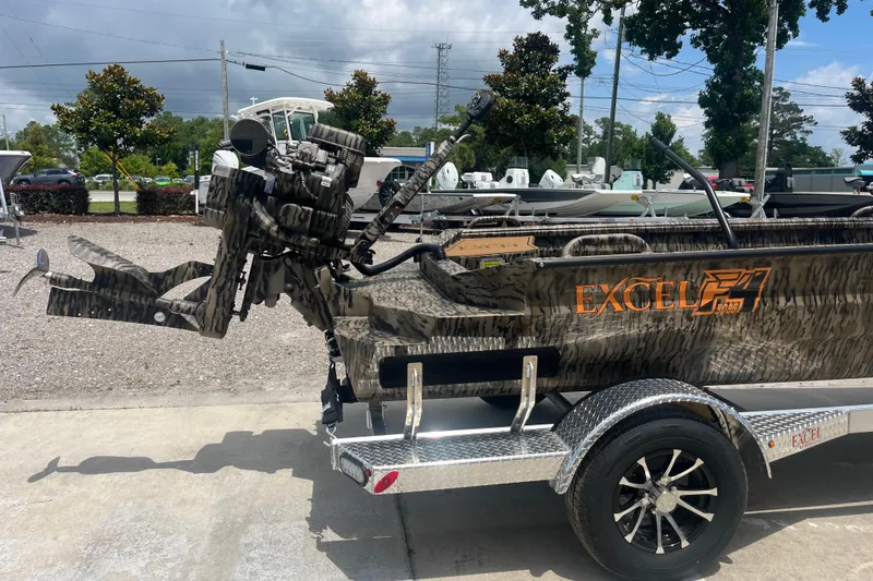 Slide: The Image of Excel 1854 F4 Pro boat, 2026 model, with camouflage design on a trailer. - 4