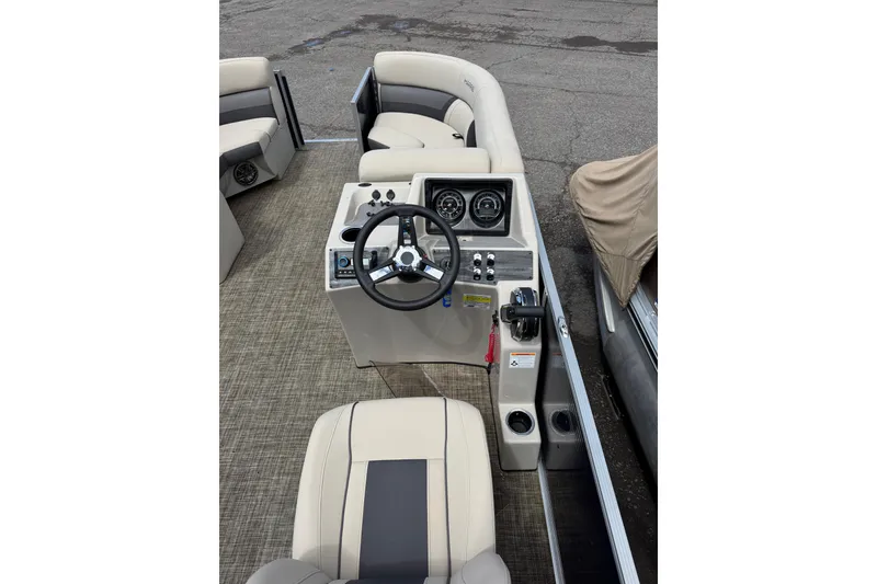 Slide: The Image of 2023 Harris Cruiser 210 CW boat interior with steering console and seating. - 3