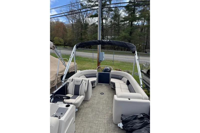 Slide: The Image of 2023 Harris Cruiser 210 CW pontoon boat with spacious seating and canopy. - 8