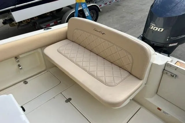 Slide: The Image of 2015 Chris-Craft Catalina 23 boat interior with beige cushioned seating and Yamaha 300 engine. - 11