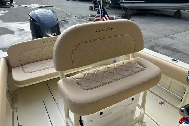 Slide: The Image of 2015 Chris-Craft Catalina 23 boat interior with beige seating and American flag. - 14