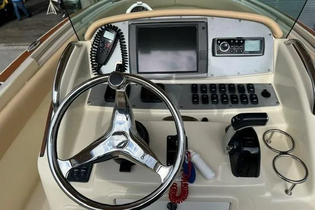 Slide: The Image of Steering console of a 2015 Chris-Craft Catalina 23 boat with modern controls. - 16
