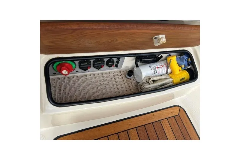Slide: The Image of Storage compartment in a 2015 Chris-Craft Catalina 23 boat with various equipment. - 18