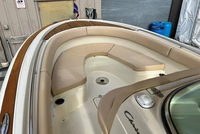 Slide: The Image of 2015 Chris-Craft Catalina 23 boat interior with beige seating and wood accents. - 19