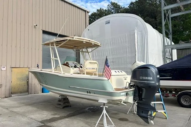 Slide: The Image of 2015 Chris-Craft Catalina 23 boat with Yamaha engine, docked near storage facility. - 2