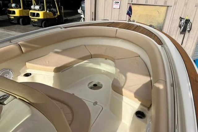 Slide: The Image of 2015 Chris-Craft Catalina 23 boat interior with beige seating and wood accents. - 20