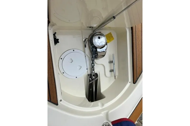Slide: The Image of Anchor compartment of 2015 Chris-Craft Catalina 23 boat with chain and cleat. - 22