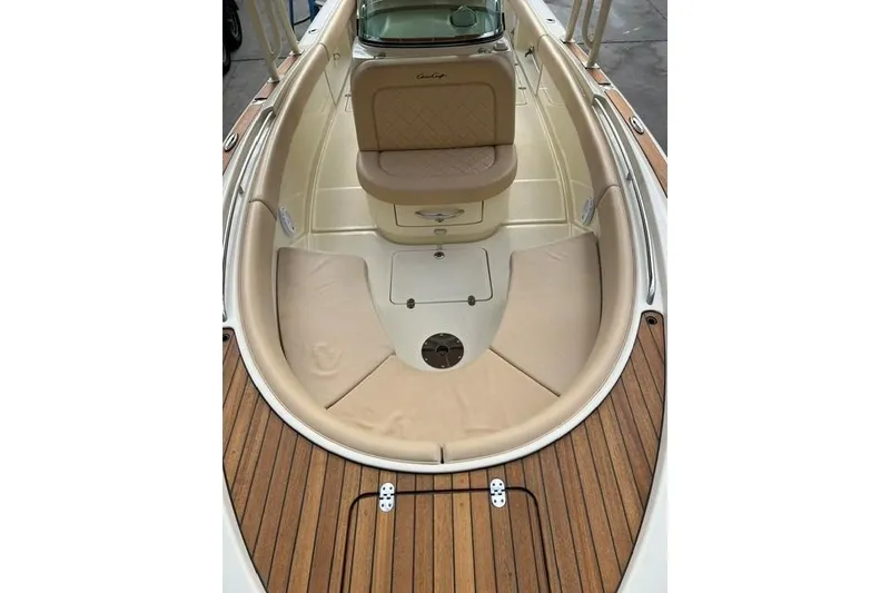 Slide: The Image of 2015 Chris-Craft Catalina 23 boat interior with teak flooring and cushioned seating. - 24