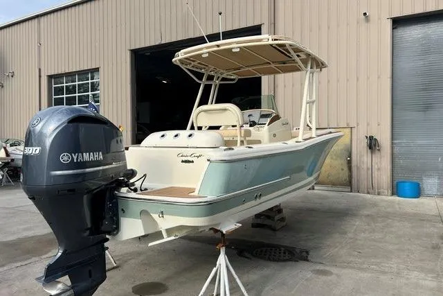Slide: The Image of 2015 Chris-Craft Catalina 23 boat with Yamaha engine, parked outside a warehouse. - 4