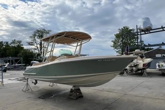Slide: The Image of 2015 Chris-Craft Catalina 23 boat on dry dock under cloudy sky. - 6