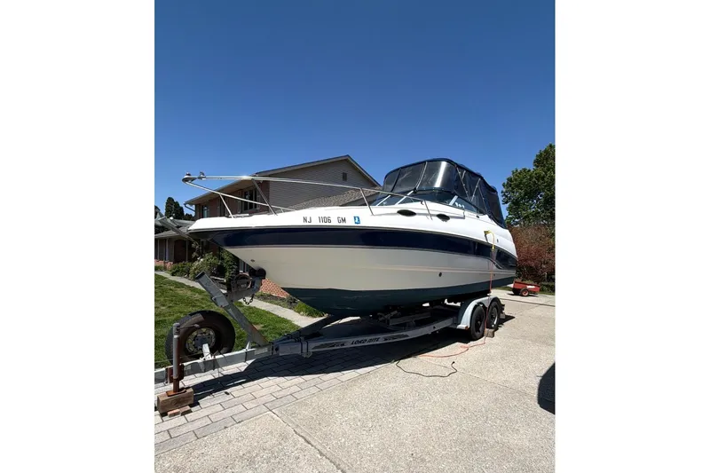 The Image of 2000 Chaparral Signature 240 boat on trailer in residential driveway. - 1
