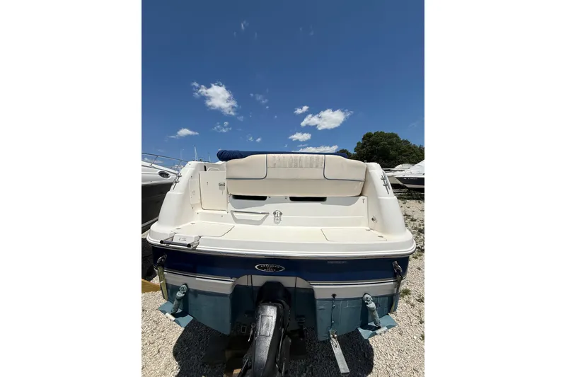 Slide: The Image of 2000 Chaparral Signature 240 boat rear view under clear blue sky. - 14