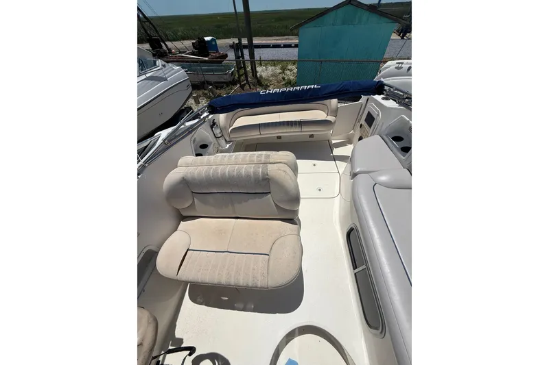 Slide: The Image of 2000 Chaparral Signature 240 boat interior with beige seating and blue cover. - 16