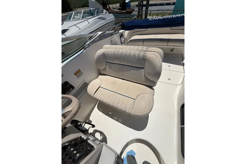 Slide: The Image of 2000 Chaparral Signature 240 boat interior with beige seating and steering wheel. - 18