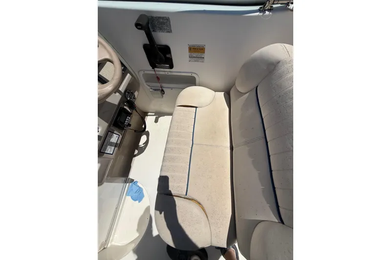 Slide: The Image of 2000 Chaparral Signature 240 boat interior with beige seating and control panel. - 22