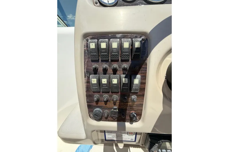 Slide: The Image of Control panel of a 2000 Chaparral Signature 240 boat with switches and dials. - 23