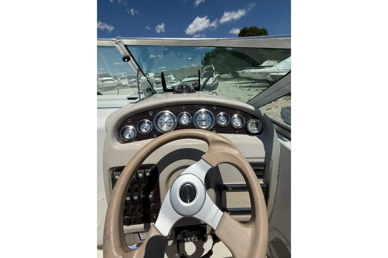 Slide: The Image of Cockpit view of a 2000 Chaparral Signature 240 boat with steering wheel and gauges. - 25