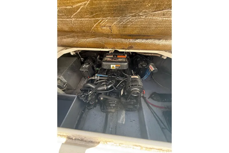 Slide: The Image of Engine compartment of a 2000 Chaparral Signature 240 boat, showcasing mechanical components. - 26