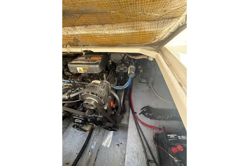 Slide: The Image of Engine compartment of a 2000 Chaparral Signature 240 boat, showcasing mechanical components. - 27
