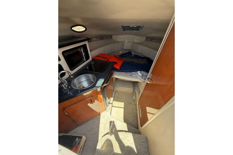 Slide: The Image of Interior of 2000 Chaparral Signature 240 boat with kitchenette and sleeping area. - 32